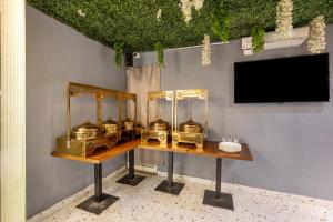 a room with a table with gold items on it at Treebo Parth Paradise in Ghaziabad +35 photos