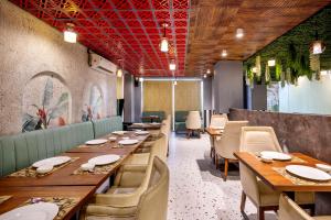 a dining room with wooden tables and chairs at Treebo Parth Paradise in Ghaziabad