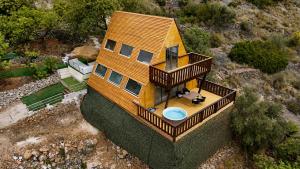 an overhead view of a house with a balcony at Cabin with jacuzzi and spectacular views in Oliva