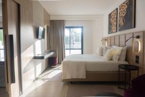 a hotel room with a bed and a balcony at Golf Residence- Families and Couples Only in Hammam Sousse