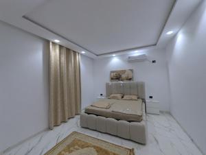 a bedroom with a bed and a large window at Azmouni in Midoun