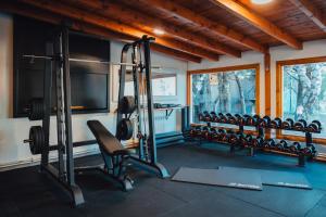 a gym with a row of tread machines in a room at Complejo Base 41 in San Carlos de Bariloche