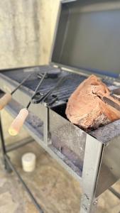 a grill with a loaf of bread on it at Ñireco HOUSE in San Carlos de Bariloche