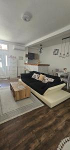 a bedroom with a large bed and a table at Apartman FIKA in Prijepolje