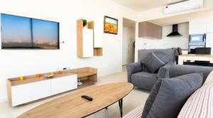 a living room with a couch and a table at Healthy Apartments Abelia Residence in Iskele