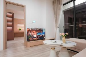 a living room with a couch and a fireplace at Ataraxia Residences in Gò Công