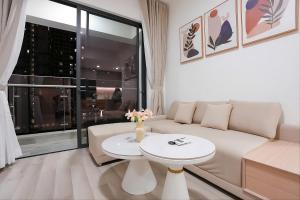 a living room with a couch and a table at Ataraxia Residences in Gò Công
