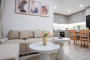 a living room with a couch and a table at Ataraxia Residences in Gò Công