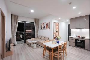 a kitchen and living room with a table and a couch at Ataraxia Residences in Gò Công
