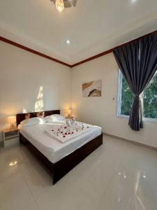 a bedroom with a large bed with roses on it at Srithanu sea Villa in Srithanu