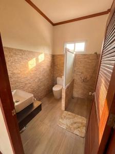 a bathroom with a sink and a toilet and a shower at Srithanu sea Villa in Srithanu +1 photo