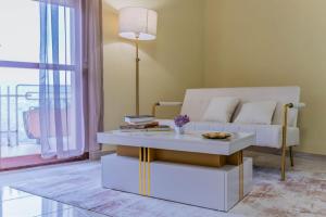 a living room with a white couch and a table at Gold House in Lungro +7 photos