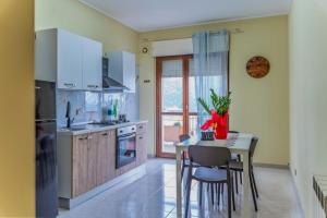 a kitchen with a table and a table and chairs at Gold House in Lungro