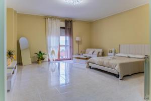 a large bedroom with a bed and a living room at Gold House in Lungro