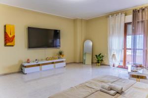 a large living room with a flat screen tv on the wall at Gold House in Lungro