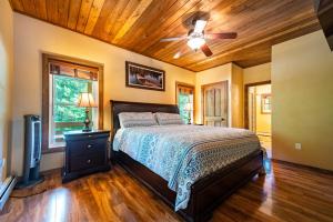 a bedroom with a bed and a ceiling fan at Large Luxury Home, Close to Whiteface, Lake Placid in Wilmington