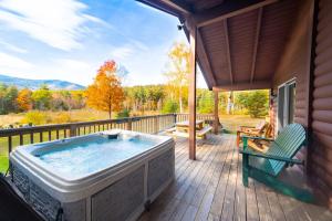 a hot tub on the deck of a house at Mountain Home, Views, Near Whiteface, Lake Placid in Wilmington +59 photos