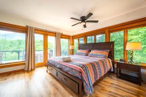 a bedroom with a bed and large windows at Breathtaking Views Near Lake Placid and Whiteface in Wilmington
