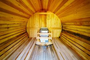 a wooden room with a bed in a log cabin at Adirondack Retreat Near Whiteface and Lake Placid in Wilmington