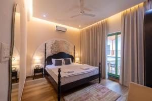 a bedroom with a bed and a large window at Luxury 3BHK Villa with Private Pool & PS5 in North in Socorro +41 photos