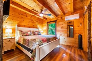 a bedroom with a bed in a log cabin at Luxury ADK Retreat Near Whiteface, Lake Placid in Jay
