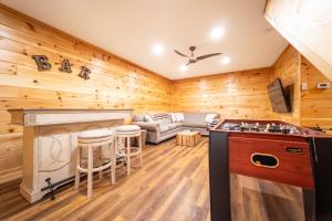 a kitchen and living room with wood paneling at Luxury ADK Retreat Near Whiteface, Lake Placid in Jay