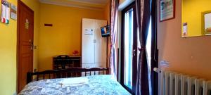 a bedroom with a bed next to a window at Complesso Turistico Aurora - camere & Appartamenti in Poggio Picenze