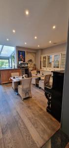 a large room with a piano and tables and chairs at B&B Villa Des Raisins in Bruges