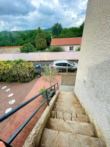 a set of stairs with a car in a parking lot at appartement de la voie verte in Hauterive
