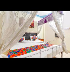 a bedroom with a bed with a canopy at Hanuman Ghat Boutique Stays by Cafe Helsinki in Udaipur