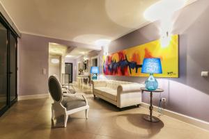 a living room with a couch and a painting on the wall at Villa do Paul by LovelyStay in Paul do Mar