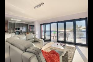 a living room with a couch and a table at Villa do Paul by LovelyStay in Paul do Mar