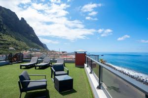 a balcony with chairs and a view of the ocean at Villa do Paul by LovelyStay in Paul do Mar