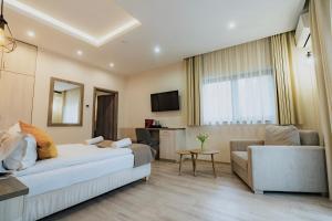 a living room with a bed and a couch at Amethyst in Sovata
