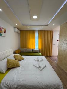 a large white bed in a room with a bed sqor at Apartmani Slađo in Trebinje