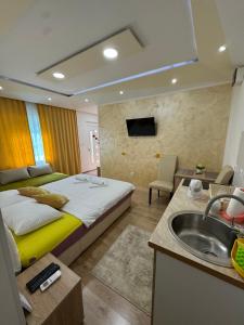 a hotel room with a bed and a sink at Apartmani Slađo in Trebinje