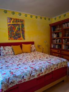 a bedroom with a bed and a book shelf at Ferienwohnung Käthe in Filipstad