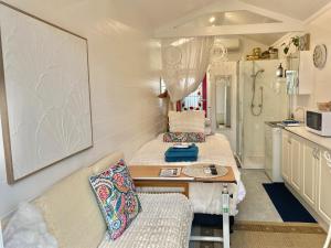 a room with two beds and a table in a caravan at Studio 59 Newport sleeps1 in Newport