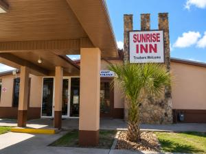 a sunrise inn sign in front of a building at Sunrise Inn - Bradenton in Bradenton