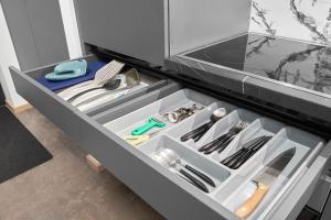 a drawer in a refrigerator filled with utensils at Homly S22 in Riga +128 photos