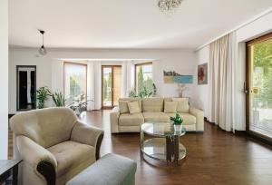a living room with two couches and a glass table at Biały Dom in Gdańsk