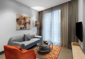 a living room with a couch and a table at Bomonti Suites Istanbul in Istanbul