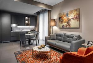 a living room with a couch and a table at Bomonti Suites Istanbul in Istanbul