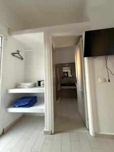 a room with a hallway with white shelves at Klouvas apartment in Klouvas
