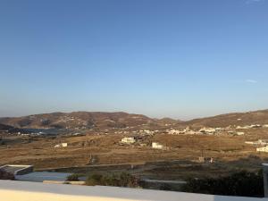 a view of a field with houses and mountains at Klouvas apartment in Klouvas
