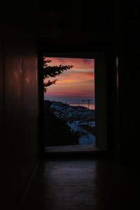 a window with a view of a city at sunset at Memmo Alfama - Design Hotels in Lisbon
