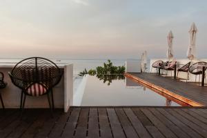 a deck with chairs and a table with a view of the water at Memmo Alfama - Design Hotels in Lisbon +93 photos