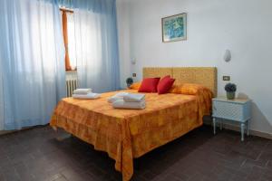 a bedroom with a large bed with red pillows on it at Meublè Andrea Doria in Torre del Lago Puccini