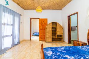 a room with a bed and a book shelf at Tanema Creek in Brufut