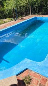 a blue swimming pool with blue water at El Rancho in Villa Giardino